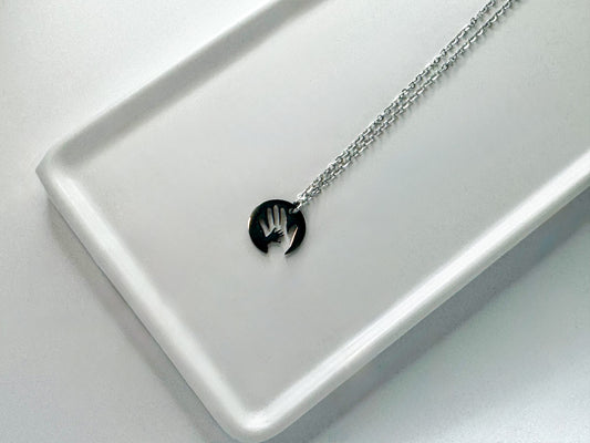Stainless “hand in mine” necklace